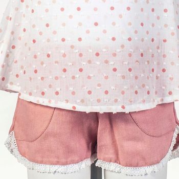 Detalle del pantalón corto del conjunto de niña en tono rosa